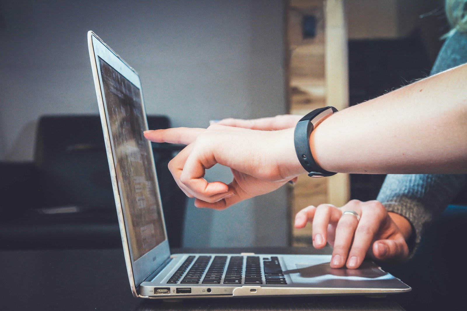 A person reviewing research and website copy on a laptop before publication.