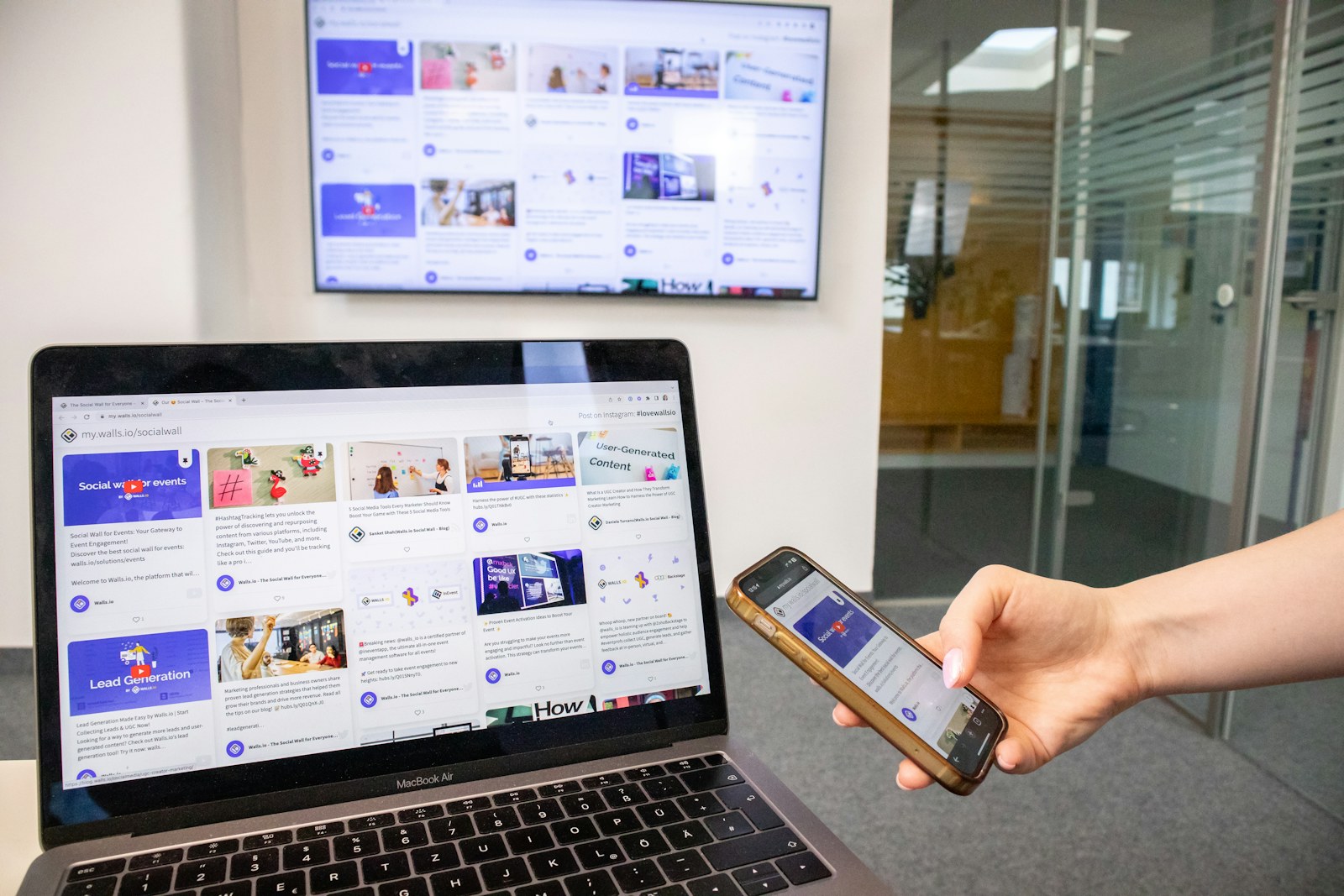 A responsive website being checked on a smartphone and laptop.